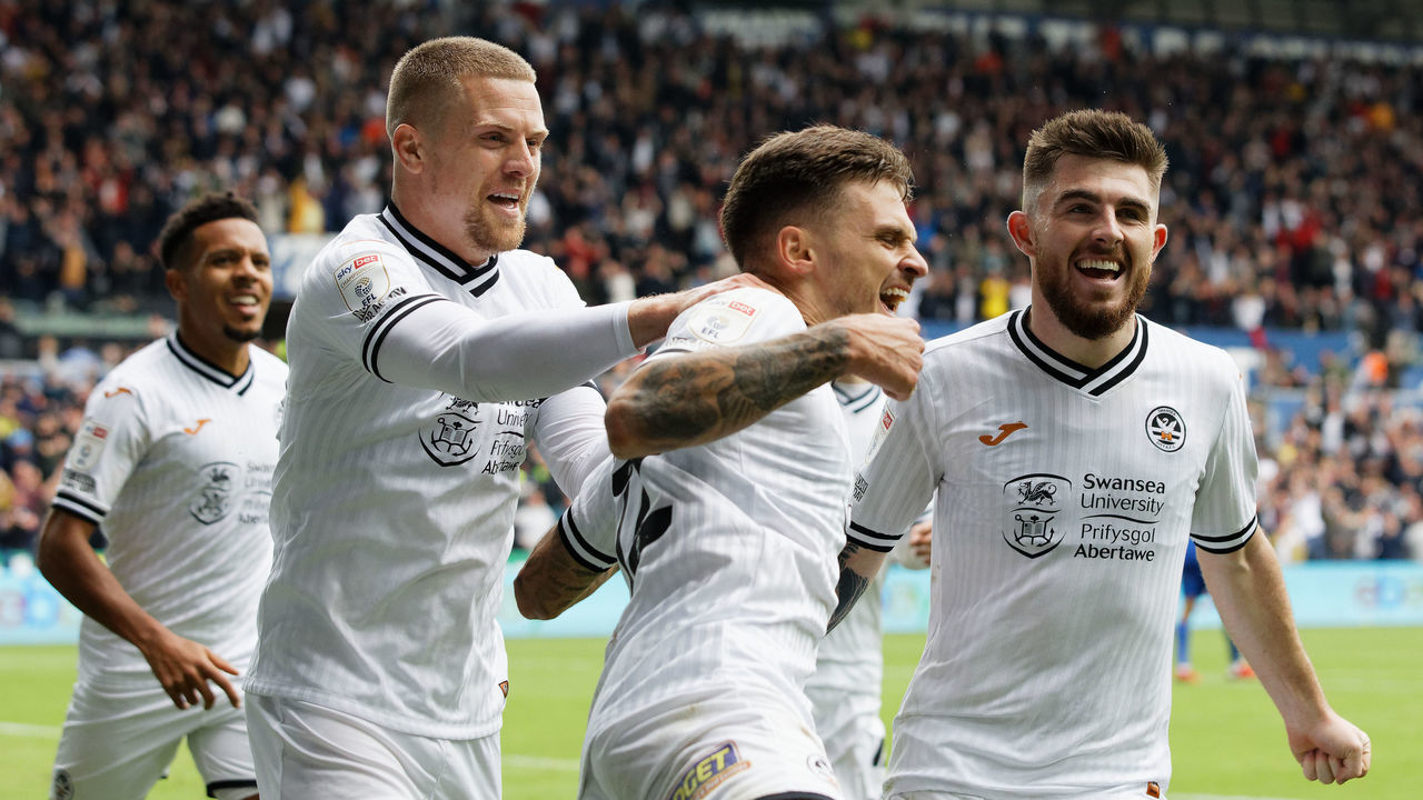SWANSEA, WALES - OCTOBER 17: Jamie Paterson of Swansea City (C) celebrates his goal with team mates Jake Bidwell (L) and Ryan Manning (R) during the Sky Bet Championship match between Swansea City and Cardiff City at the Swansea.com Stadium on October 17, 2021 in Swansea, Wales.