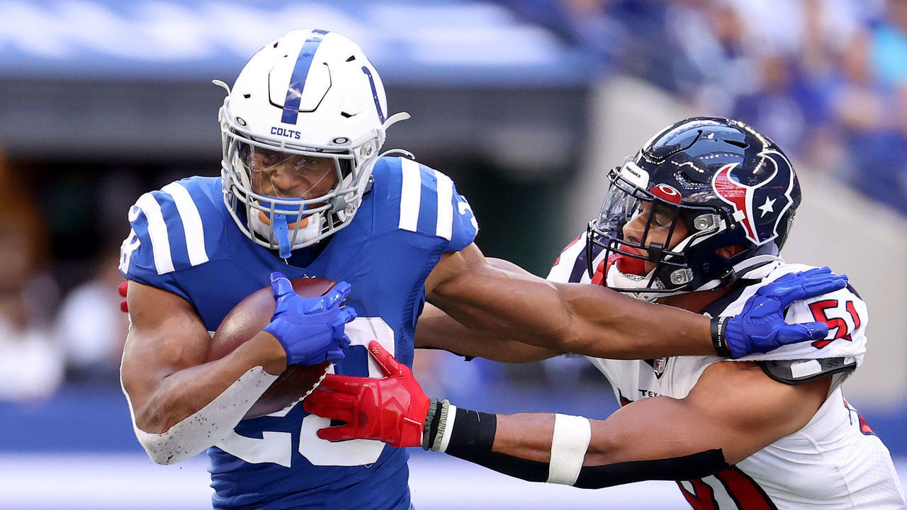 INDIANAPOLIS, INDIANA - OCTOBER 17: Jonathan Taylor #28 of the Indianapolis Colts runs with the ball against Kamu Grugier-Hill #51 of the Houston Texans in the second half at Lucas Oil Stadium on October 17, 2021 in Indianapolis, Indiana.
