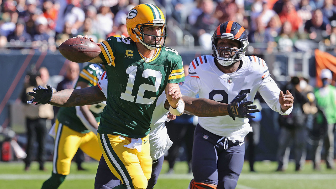 CHICAGO, ILLINOIS - OCTOBER 17: Aaron Rodgers #12 of the Green Bay Packers passes under pressure from Mario Edwards #97 and Robert Quinn #94 of the Chicago Bears at Soldier Field on October 17, 2021 in Chicago, Illinois. The Packers defeated the Bears 24-14.
