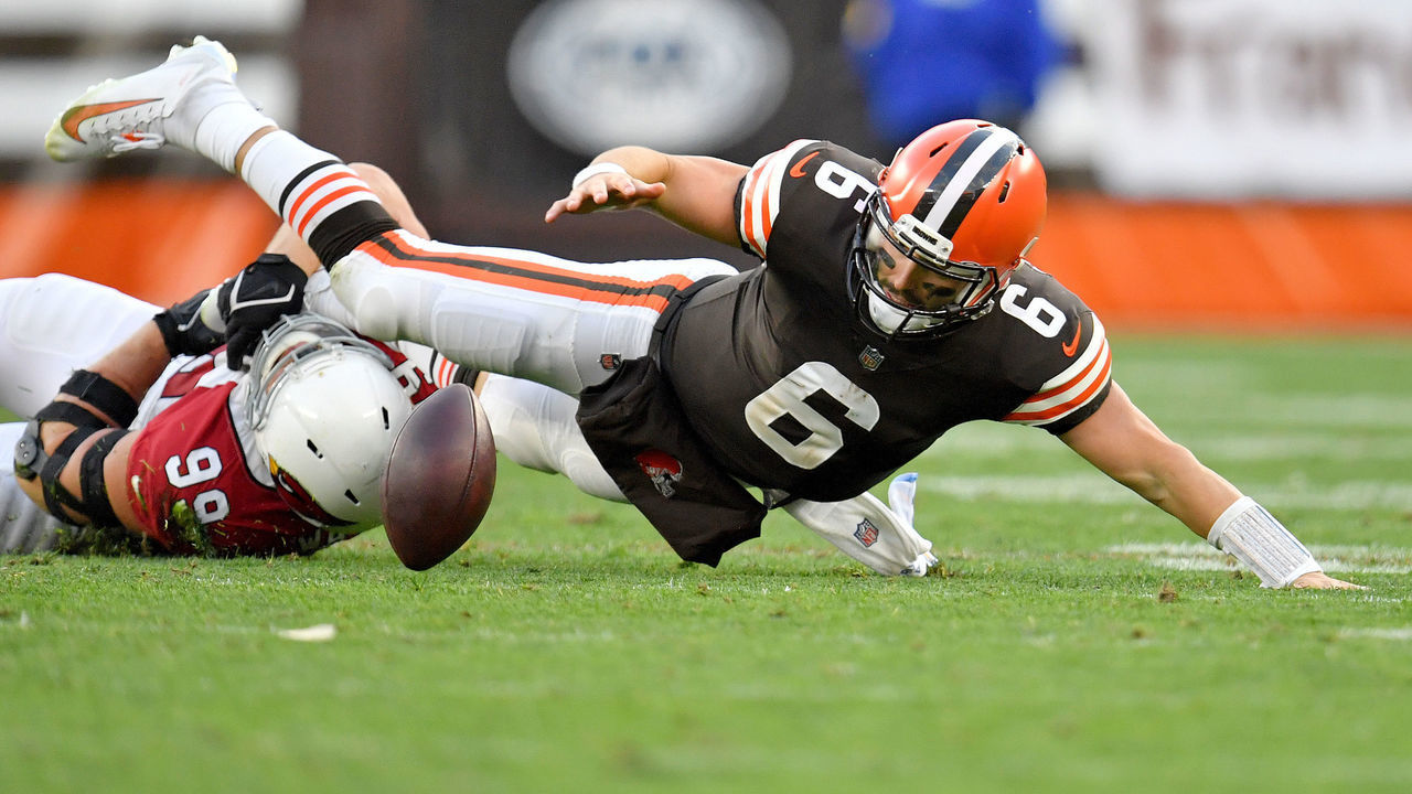 CLEVELAND, OHIO - OCTOBER 17: Baker Mayfield #6 of the Cleveland Browns fumbles the ball after a tackle from J.J. Watt #99 of the Arizona Cardinals during the third quarter at FirstEnergy Stadium on October 17, 2021 in Cleveland, Ohio.