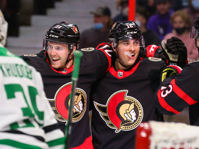 OTTAWA, ONTARIO - OCTOBER 17: Chris Tierney #71 of the Ottawa Senators celebrates his second period goal with Shane Pinto #12 and Zach Sanford #13 against the Dallas Stars at Canadian Tire Centre on October 17, 2021 in Ottawa, Ontario.