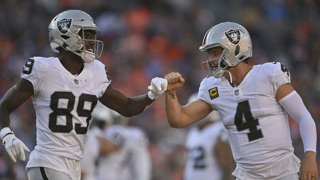 DENVER, COLORADO - OCTOBER 17: Bryan Edwards #89 of the Las Vegas Raiders and Derek Carr #4 celebrate during the third quarter against the Denver Broncos at Empower Field At Mile High on October 17, 2021 in Denver, Colorado.