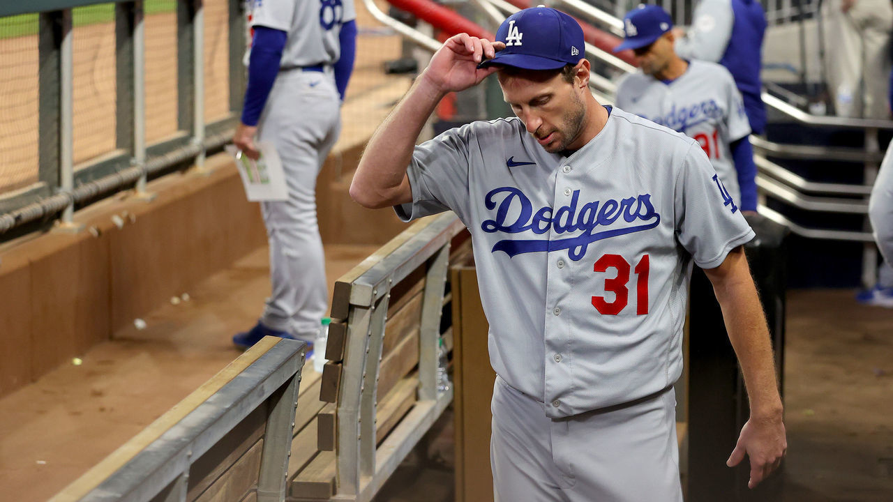 ATLANTA, GEORGIA - OCTOBER 17: Max Scherzer #31 of the Los Angeles Dodgers stands in the dugout after he was taken out of the game against the Atlanta Braves in the fifth inning of Game Two of the National League Championship Series at Truist Park on October 17, 2021 in Atlanta, Georgia.