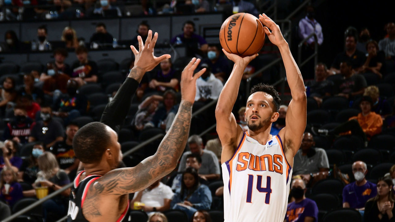 PHOENIX, AZ - OCTOBER 13: Landry Shamet #14 of the Phoenix Suns shoots a three point basket during a preseason game against the Portland Trail Blazers on October 13, 2021 at Footprint Center in Phoenix, Arizona. Mandatory Copyright Notice: Copyright 2021 NBAE