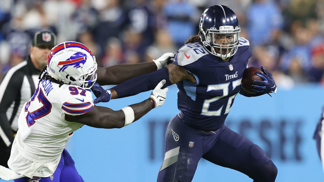 NASHVILLE, TENNESSEE - OCTOBER 18: Running back Derrick Henry #22 of the Tennessee Titans rushes past defensive end Mario Addison #97 of the Buffalo Bills during the first half at Nissan Stadium on October 18, 2021 in Nashville, Tennessee.