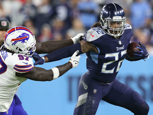 NASHVILLE, TENNESSEE - OCTOBER 18: Running back Derrick Henry #22 of the Tennessee Titans rushes past defensive end Mario Addison #97 of the Buffalo Bills during the first half at Nissan Stadium on October 18, 2021 in Nashville, Tennessee.