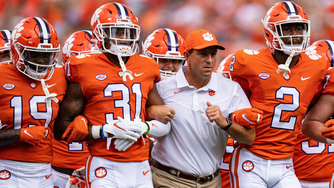 CLEMSON, SOUTH CAROLINA - SEPTEMBER 18: Head coach Dabo Swinney of the Clemson Tigers links arms with players before their game against the Georgia Tech Yellow Jackets at Clemson Memorial Stadium on September 18, 2021 in Clemson, South Carolina.