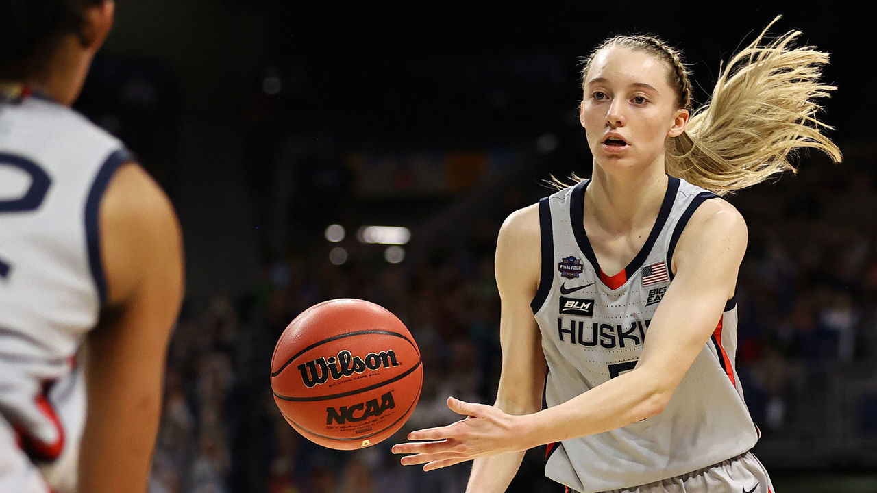 SAN ANTONIO, TEXAS - APRIL 02: Paige Bueckers #5 of the UConn Huskies passes to Evina Westbrook #22 against the Arizona Wildcats during the second quarter in the Final Four semifinal game of the 2021 NCAA Women's Basketball Tournament at the Alamodome on April 02, 2021 in San Antonio, Texas.