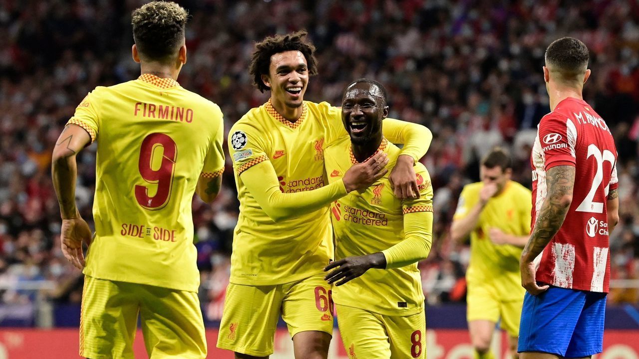 Liverpool's Guinean midfielder Naby Keita (R) celebrates with teammate Liverpool's English defender Trent Alexander-Arnold after scoring a goal during the UEFA Champions League Group B football match between Atletico Madrid and Liverpool at the Wanda Metropolitano stadium in Madrid on October 19, 2021.