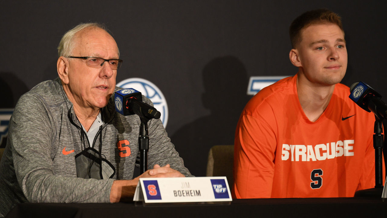 CHARLOTTE, NC - OCTOBER 12: Syracuse Orange head coach Jim Boeheim sits by son Buddy Boeheim while responding to questions during the ACC Basketball Tipoff on October 12, 2021, at the Charlotte Marriott City Center in Charlotte, NC.