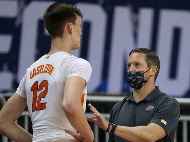 INDIANAPOLIS, INDIANA - MARCH 21: Head coach Mike White of the Florida Gators speaks to Colin Castleton #12 in the first half against the Oral Roberts Golden Eagles in the second round game of the 2021 NCAA Men's Basketball Tournament at Indiana Farmers Coliseum on March 21, 2021 in Indianapolis, Indiana.