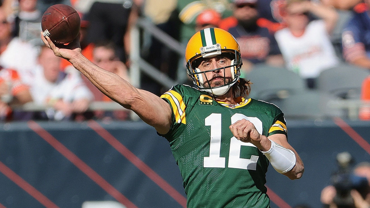 CHICAGO, ILLINOIS - OCTOBER 17: Aaron Rodgers #12 of the Green Bay Packers passes under pressure from Robert Quinn #94 and Eddie Goldman #91 of the Chicago Bears at Soldier Field on October 17, 2021 in Chicago, Illinois. The Packers defeated the Bears 24-14.