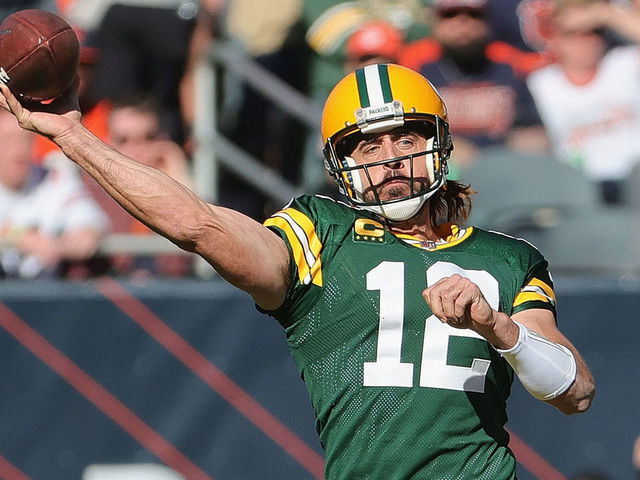 CHICAGO, ILLINOIS - OCTOBER 17: Aaron Rodgers #12 of the Green Bay Packers passes under pressure from Robert Quinn #94 and Eddie Goldman #91 of the Chicago Bears at Soldier Field on October 17, 2021 in Chicago, Illinois. The Packers defeated the Bears 24-14.