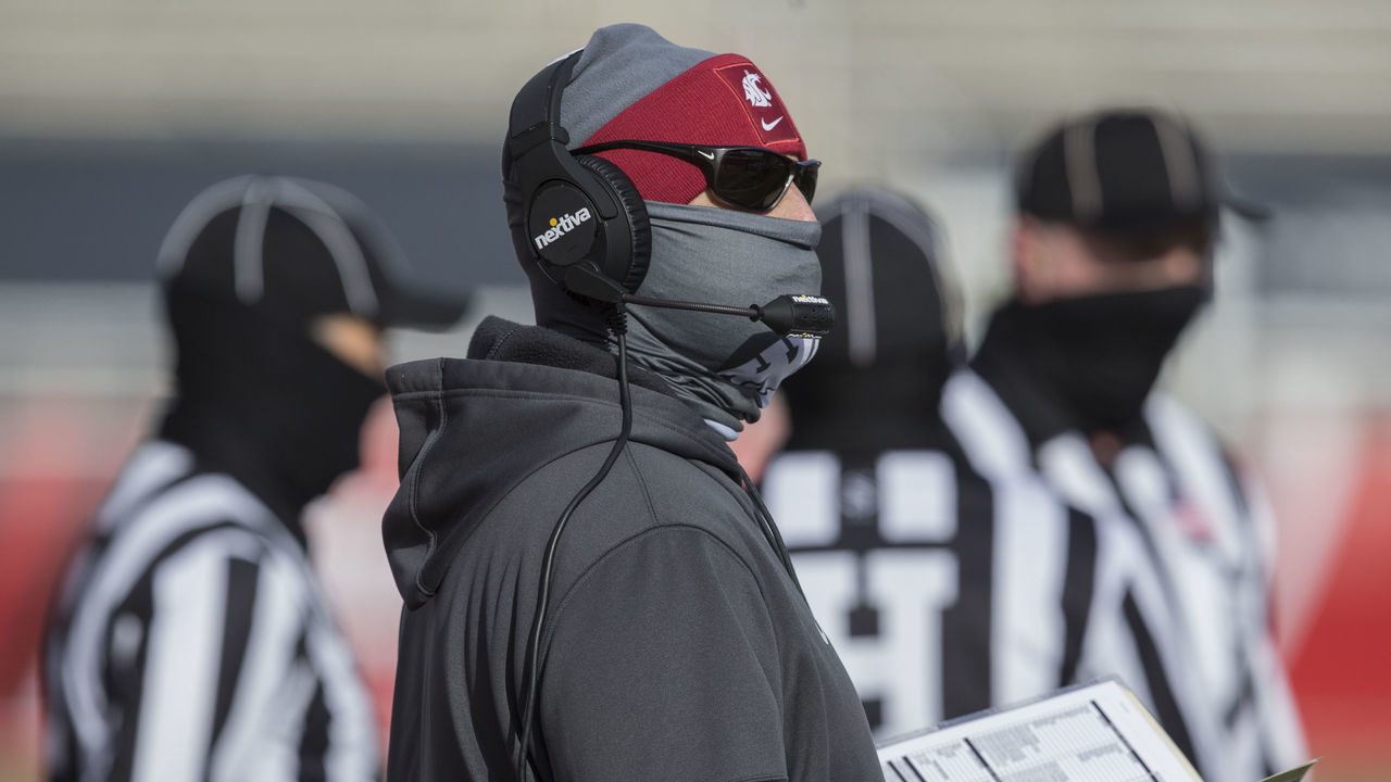 SALT LAKE CITY, UT - DECEMBER 19: Nick Rolovich head coach of the Washington State Cougars looks over his play sheet during their game against the Utah Utes on December 19, 2020 at Rice Eccles Stadium in Salt Lake City, Utah.