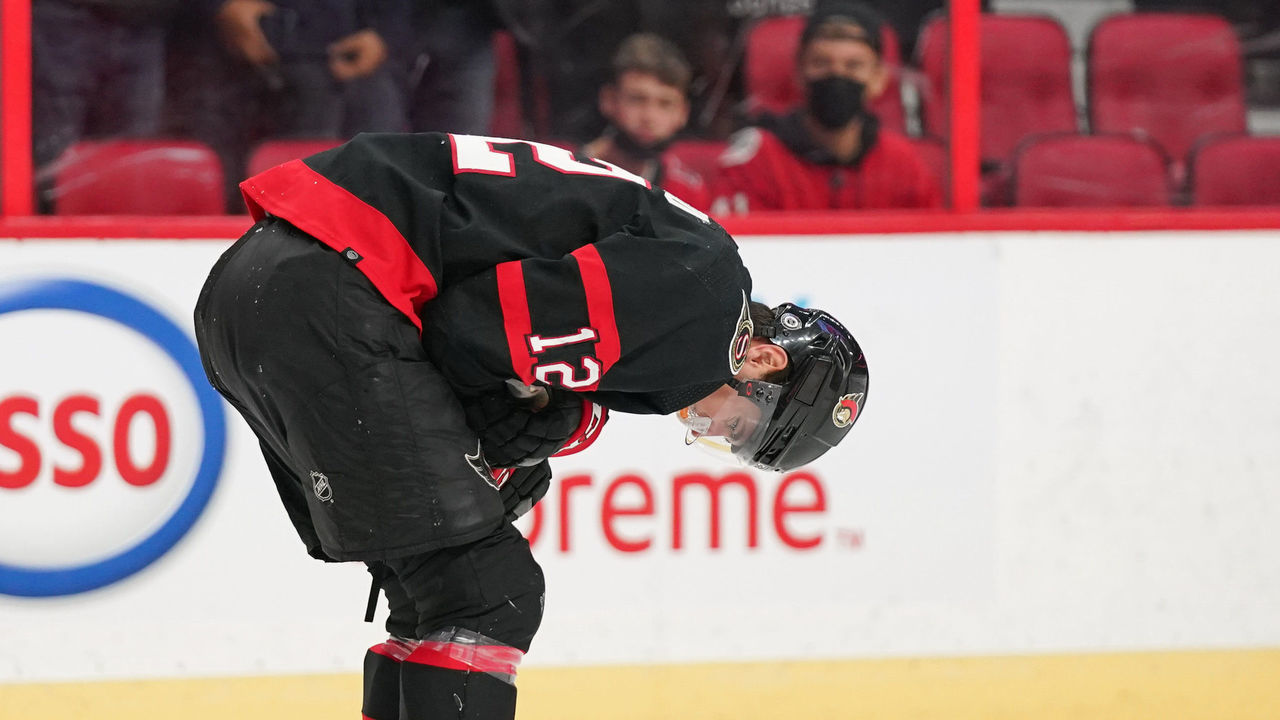 OTTAWA, ON - OCTOBER 21: Shane Pinto #12 of the Ottawa Senators hunches over as he leaves the game after an injury in the first period of a game against the Dallas Stars at Canadian Tire Centre on October 21, 2021 in Ottawa, Ontario, Canada.