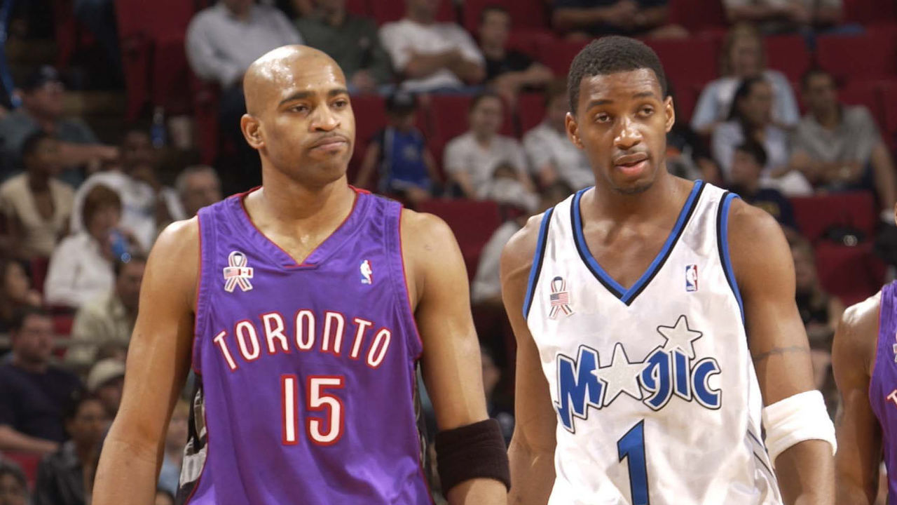 10 Mar 2002: Tracy McGrady #1 of the Orlando Magic meets up with cousin Vince Carter #15 of the Toronto Raptors in a game at TD Waterhouse Centre in Orlando, Florida. DIGITAL IMAGE. Note to User: User expressly acknowledges and agrees that by downloading and/or using this photograph, user is consenting to the terms and conditions of the Getty Images License Agreement. Mandatory Copyright Notice: Copyright 2002 NBAE/Getty Images Mandatory Credit: Fernando Medina/NBAE/Getty Images