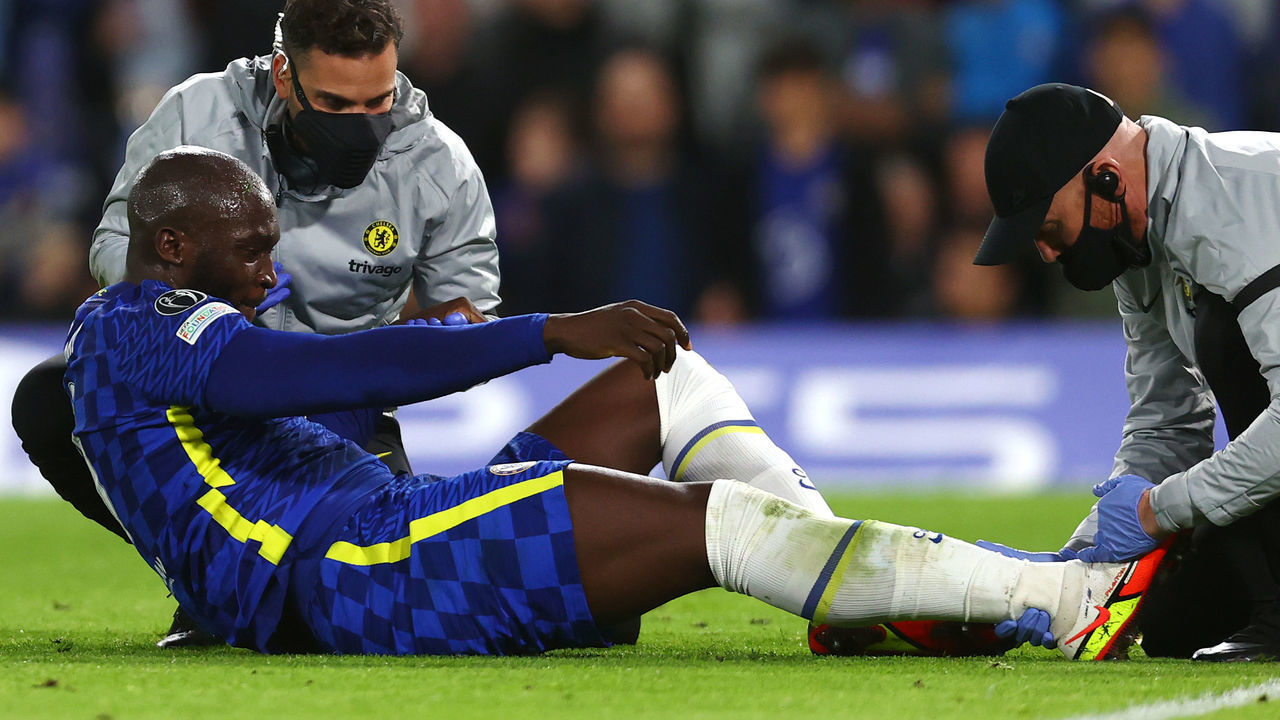 LONDON, ENGLAND - OCTOBER 20: Romelu Lukaku of Chelsea receives medical treatment during the UEFA Champions League group H match between Chelsea FC and Malmo FF at Stamford Bridge on October 20, 2021 in London, England.