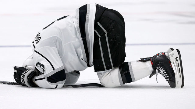 DALLAS, TEXAS - OCTOBER 22: Drew Doughty #8 of the Los Angeles Kings lays on the ice after being tripped by the Dallas Stars in the second period at American Airlines Center on October 22, 2021 in Dallas, Texas.
