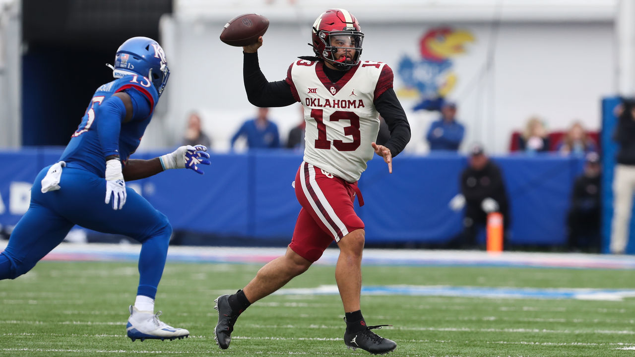 LAWRENCE, KS - OCTOBER 23: Oklahoma Sooners quarterback Caleb Williams (13) looks to pass while rolling out late in the second quarter of a Big 12 football game between the Oklahoma Sooners and Kansas Jayhawks on Oct 23, 2021 at Memorial Stadium in Lawrence, KS.