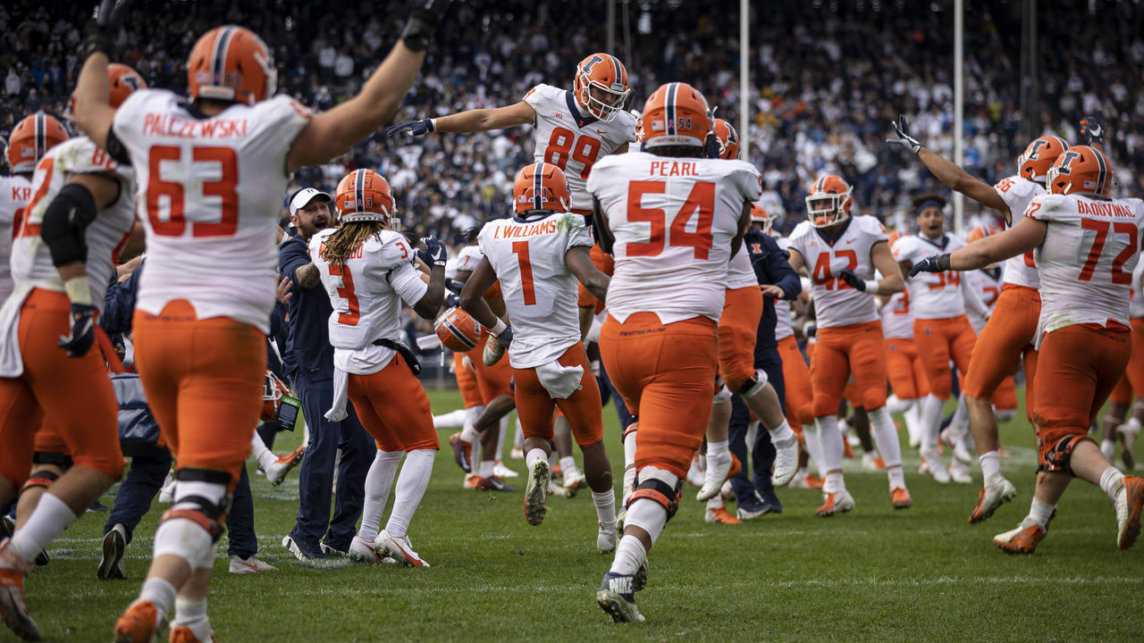 STATE COLLEGE, PA - OCTOBER 23: llinois Fighting Illini players celebrate after winning the game against the Penn State Nittany Lions in the ninth overtime at Beaver Stadium on October 23, 2021 in State College, Pennsylvania.