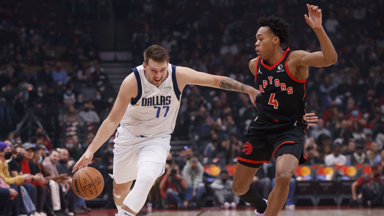 TORONTO, ON - OCTOBER 23: Luka Doncic #77 of the Dallas Mavericks drives against Scottie Barnes #4 of the Toronto Raptors during their NBA game at Scotiabank Arena on October 23, 2021 in Toronto, Canada.