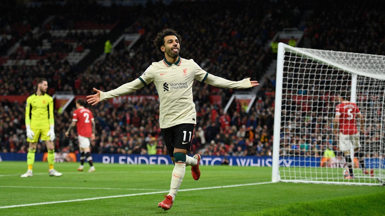 TOPSHOT - Liverpool's Egyptian midfielder Mohamed Salah celebrates after scoring their fifth goal, his third during the English Premier League football match between Manchester United and Liverpool at Old Trafford in Manchester, north west England, on October 24, 2021. - RESTRICTED TO EDITORIAL USE. No use with unauthorized audio, video, data, fixture lists, club/league logos or 'live' services. Online in-match use limited to 120 images. An additional 40 images may be used in extra time. No video emulation. Social media in-match use limited to 120 images. An additional 40 images may be used in extra time. No use in betting publications, games or single club/league/player publications.
