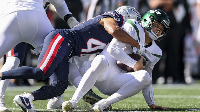 FOXBOROUGH, MASSACHUSETTS - OCTOBER 24: Myles Bryant #41 of the New England Patriots sacks Zach Wilson #2 of the New York Jets during the first quarter at Gillette Stadium on October 24, 2021 in Foxborough, Massachusetts.