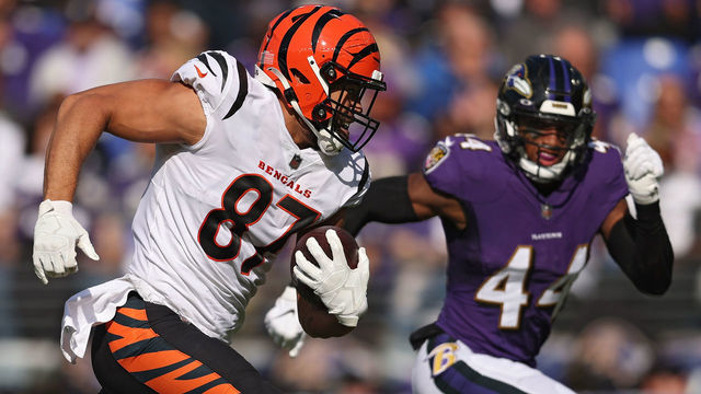 BALTIMORE, MARYLAND - OCTOBER 24: C.J. Uzomah #87 of the Cincinnati Bengals rushes with the ball before scoring a touchdown as Marlon Humphrey #44 of the Baltimore Ravens defends during the second quarter at M&T Bank Stadium on October 24, 2021 in Baltimore, Maryland.