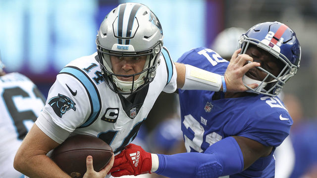 EAST RUTHERFORD, NEW JERSEY - OCTOBER 24: Sam Darnold #14 of the Carolina Panthers is sacked by Jabrill Peppers #21 of the New York Giants during the first half in the game at MetLife Stadium on October 24, 2021 in East Rutherford, New Jersey.