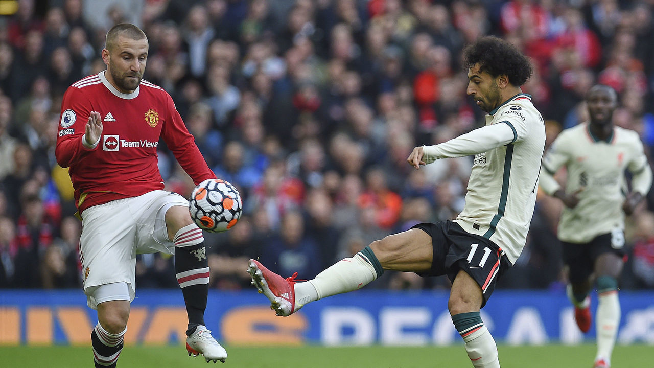 MANCHESTER, ENGLAND - OCTOBER 24: (THE SUN OUT, THE SUN ON SUNDAY OUT) Mohamed Slah of Liverpool and Luke Shaw of Manchester United in action during the Premier League match between Manchester United and Liverpool at Old Trafford on October 24, 2021 in Manchester, England.