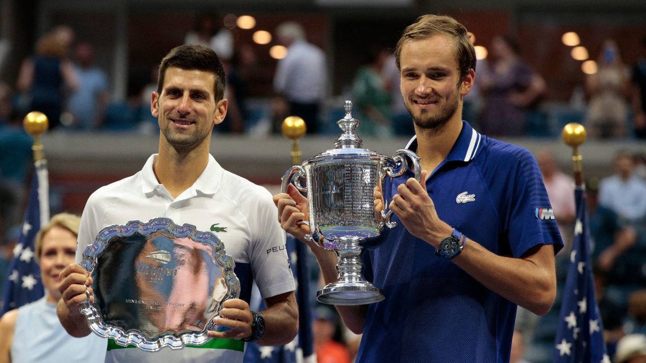 TOPSHOT - Winner Russia's Daniil Medvedev (R) and Serbia's Novak Djokovic hold their trophies after the 2021 US Open Tennis tournament men's final match against at the USTA Billie Jean King National Tennis Center in New York, on September 12, 2021.