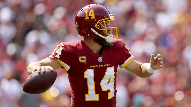 LANDOVER, MARYLAND - SEPTEMBER 12: Quarterback Ryan Fitzpatrick #14 of the Washington Football Team throws a pass against the Los Angeles Chargers at FedExField on September 12, 2021 in Landover, Maryland.