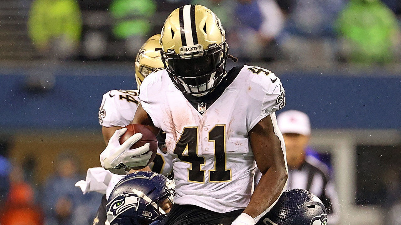 SEATTLE, WASHINGTON - OCTOBER 25: Alvin Kamara #41 of the New Orleans Saints is brought down by Tre Brown #22 and Carlos Dunlap #8 of the Seattle Seahawks during the second half at Lumen Field on October 25, 2021 in Seattle, Washington.