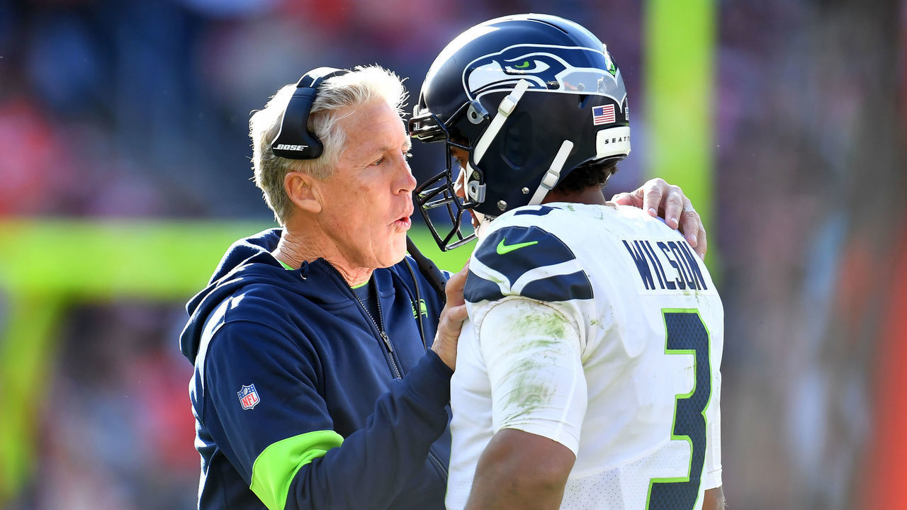 CLEVELAND, OHIO - OCTOBER 13: Head coach Pete Carroll talks with quarterback Russell Wilson #3 of the Seattle Seahawks during the second half against the Cleveland Browns at FirstEnergy Stadium on October 13, 2019 in Cleveland, Ohio. The Seahawks defeated the Browns 32-28.