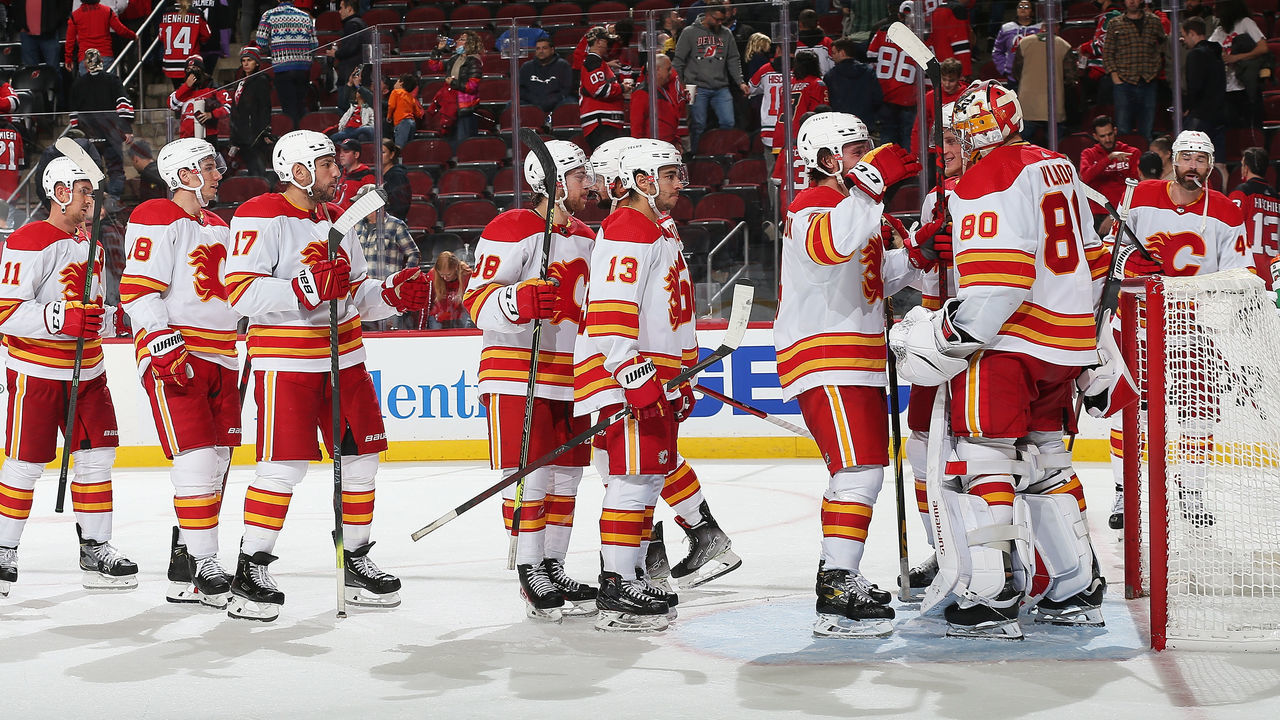 NEWARK, NEW JERSEY - OCTOBER 26: Dan Vladar #80 of the Calgary Flames celebrate after defeating the New Jersey Devils 5-3 at Prudential Center on October 26, 2021 in Newark, New Jersey.