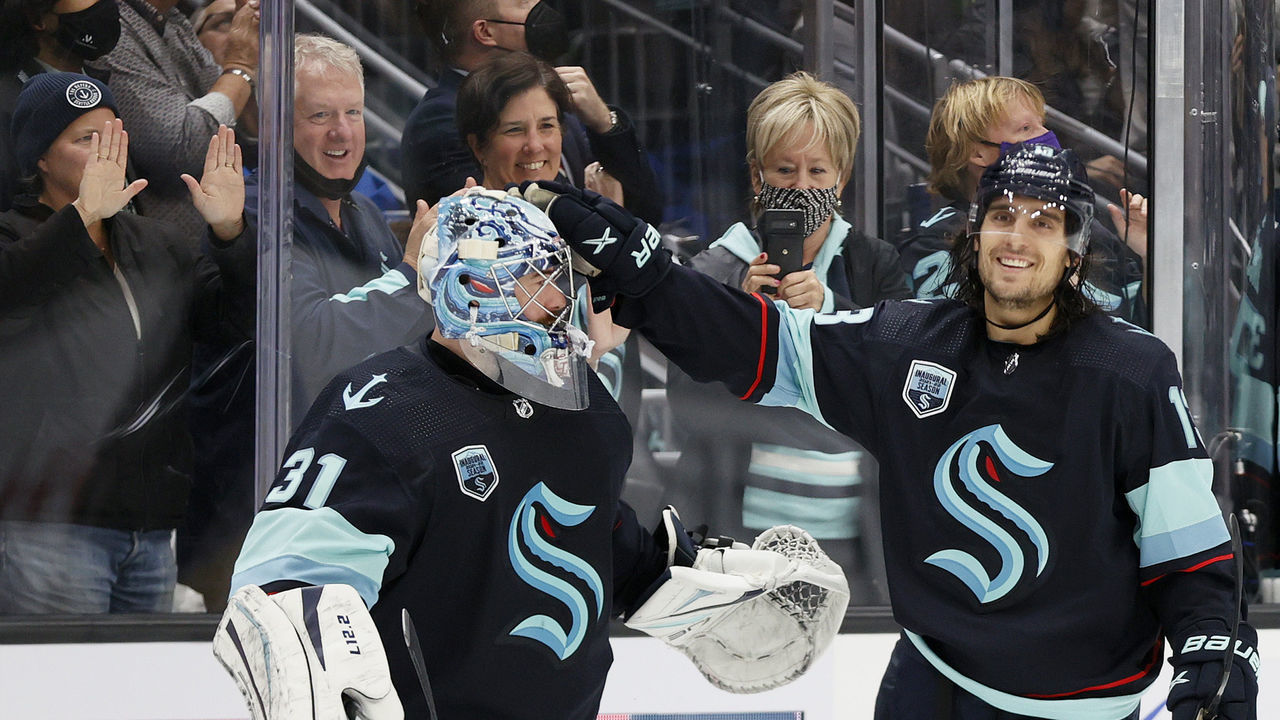 SEATTLE, WASHINGTON - OCTOBER 26: Brandon Tanev #13 of the Seattle Kraken celebrates with Philipp Grubauer #31 after his second goal against the Montreal Canadiens during the third period on October 26, 2021 at Climate Pledge Arena in Seattle, Washington.