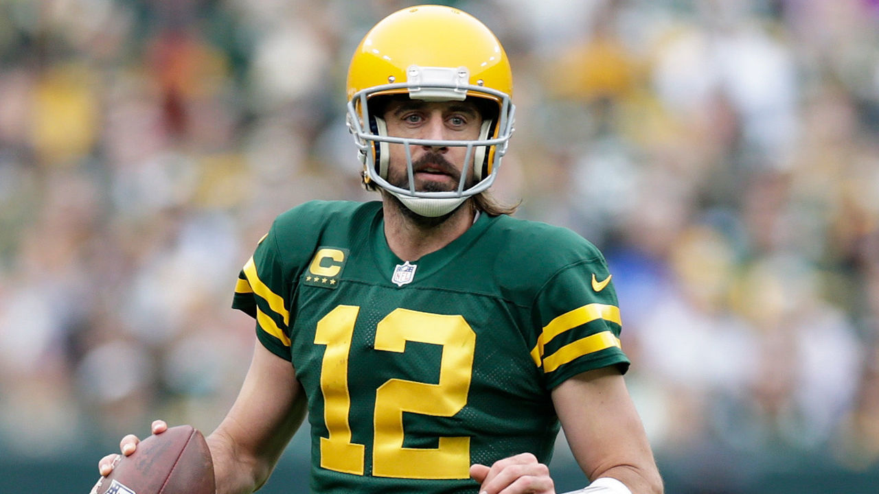 GREEN BAY, WISCONSIN - OCTOBER 24: Aaron Rodgers #12 of the Green Bay Packers scrambles to his right looking for a receiver during the game against the Washington Football Team at Lambeau Field on October 24, 2021 in Green Bay, Wisconsin. Green Bay defeated Washington 24-10.