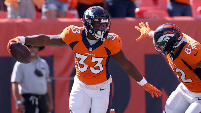 DENVER, COLORADO - SEPTEMBER 26: Javonte Williams #33 of the Denver Broncos celebrates scoring a touchdown with Eric Saubert #82 against the New York Jets at Empower Field At Mile High on September 26, 2021 in Denver, Colorado.