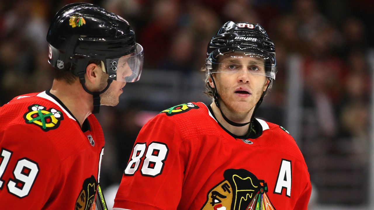 CHICAGO, ILLINOIS - DECEMBER 27: Jonathan Toews #19 of the Chicago Blackhawks talks with Patrick Kane #88 before a face-off against the New York Islanders at the United Center on December 27, 2019 in Chicago, Illinois. The Blackhawks defeated the Islanders 5-2.