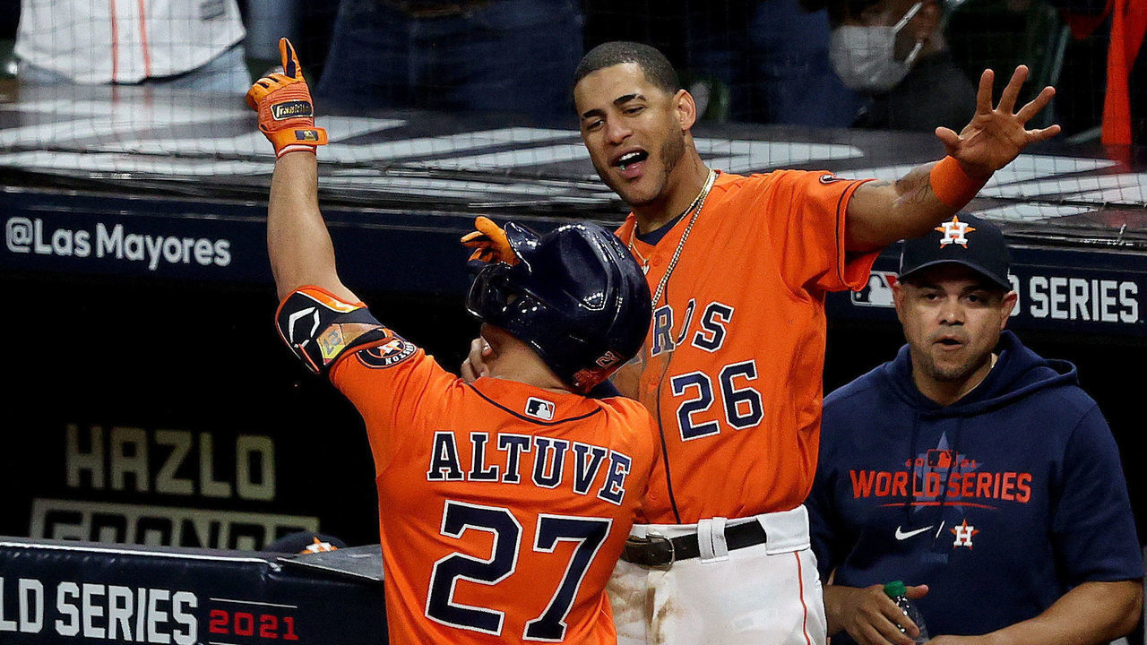 HOUSTON, TEXAS - OCTOBER 27: Jose Altuve #27 of the Houston Astros is congratulated by Jose Siri #26 after hitting a one run home run against the Atlanta Braves during the seventh inning in Game Two of the World Series at Minute Maid Park on October 27, 2021 in Houston, Texas.