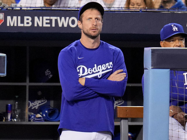 Los Angeles, CA - October 20: Max Scherzer #31 of the Los Angeles Dodgers stands at the top of the steps to watch the Atlanta Braves during the fourth inning of game 4 of the baseball National League Championship Series at Dodger Stadium on Wednesday, October 20, 2021, in Los Angeles.