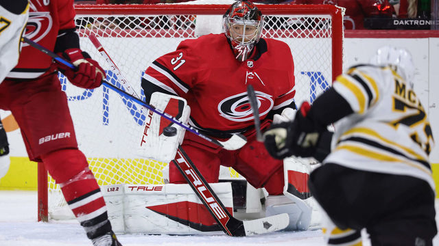 RALEIGH, NC - OCTOBER 28: Frederik Andersen #31 of the Carolina Hurricanes goes down in the crease and blockers the puck away on a shot by Charlie McAvoy #73 of the Boston Bruins during an NHL game on October 28, 2021 at PNC Arena in Raleigh, North Carolina.