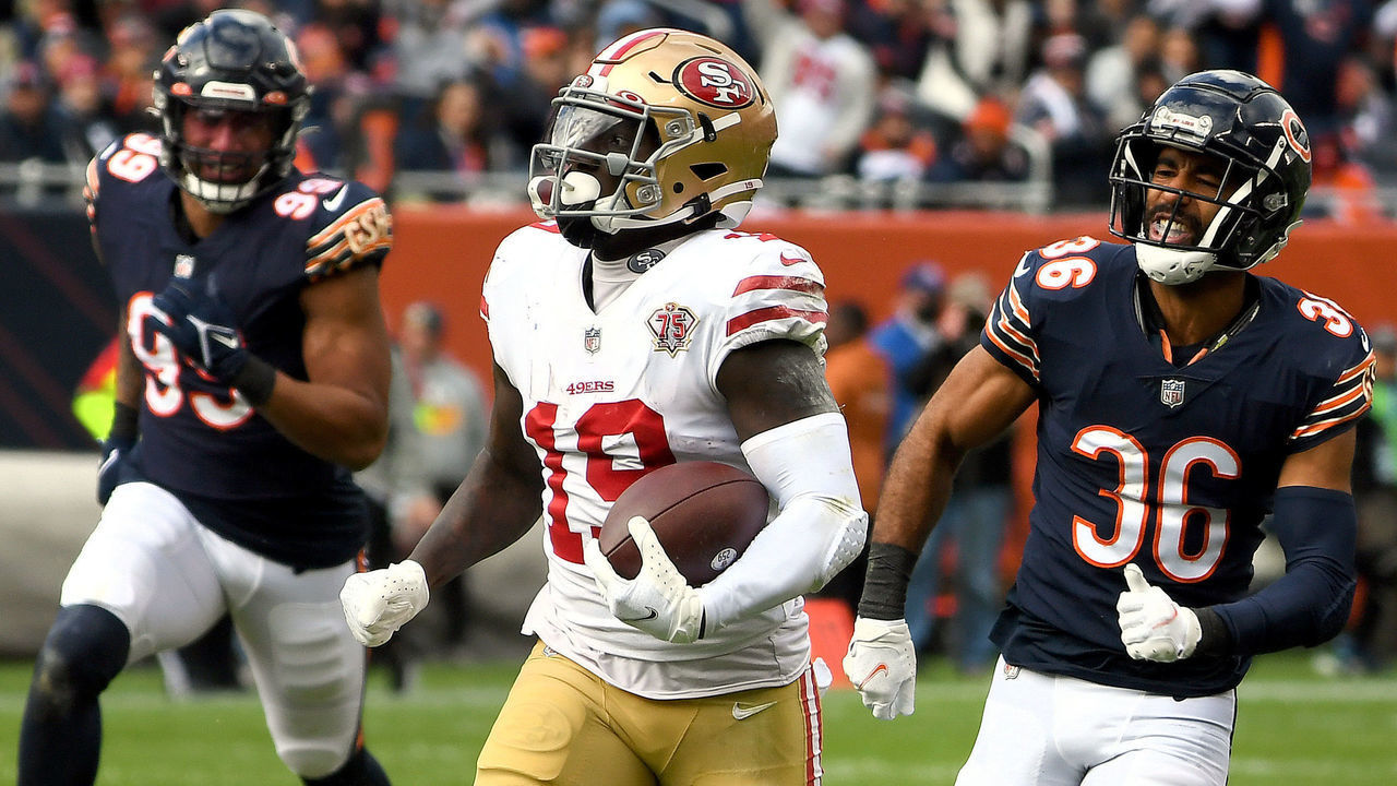 CHICAGO, ILLINOIS - OCTOBER 31: Deebo Samuel #19 of the San Francisco 49ers runs with the ball while being chased by DeAndre Houston-Carson #36 of the Chicago Bears in the third quarter at Soldier Field on October 31, 2021 in Chicago, Illinois.