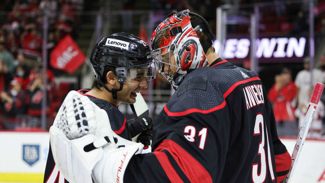 RALEIGH, NC - OCTOBER 31: Goaltender Frederik Andersen #31 of the Carolina Hurricanes is congratulated on his 2-1 victory by teammate Seth Jarvis #24 who records his first NHL point following an NHL game against the Arizona Coyotes on October 31, 2021 at PNC Arena in Raleigh, North Carolina.