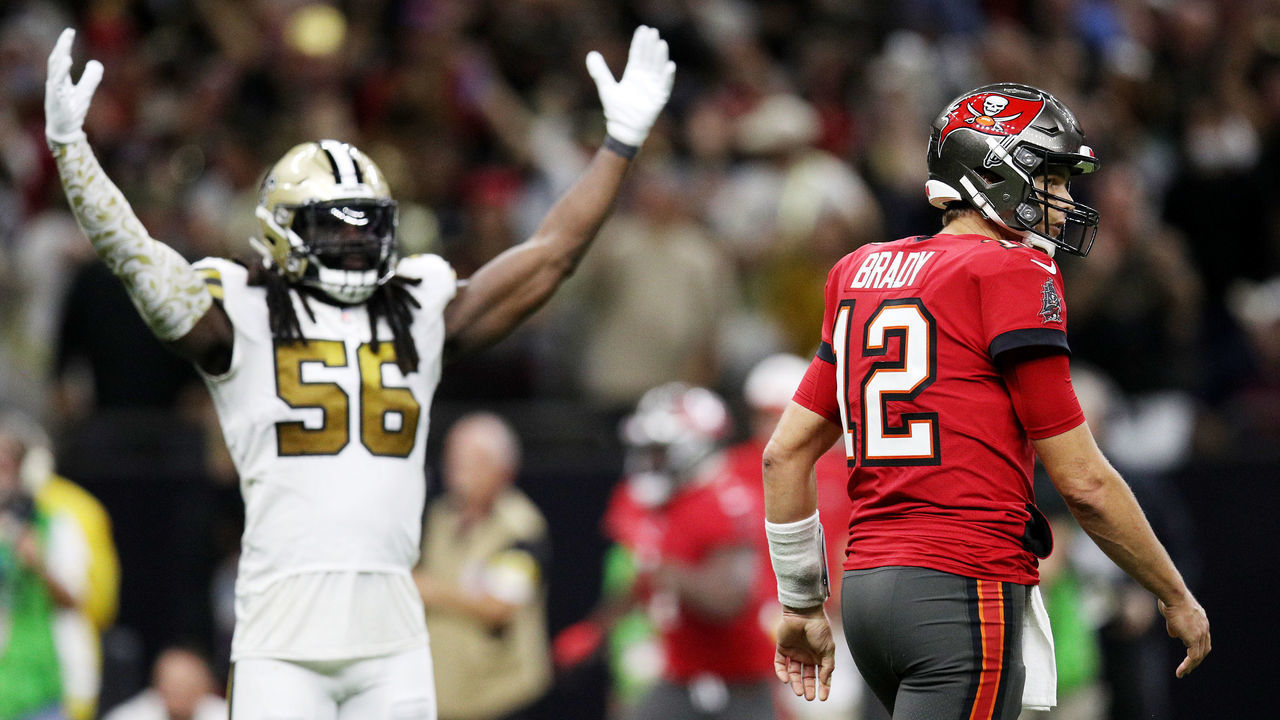 NEW ORLEANS, LOUISIANA - OCTOBER 31: Tom Brady #12 of the Tampa Bay Buccaneers and Demario Davis #56 of the New Orleans Saints react after Brady throws an interception returned for a touchdown during the fourth quarter against the New Orleans Saints at Caesars Superdome on October 31, 2021 in New Orleans, Louisiana.