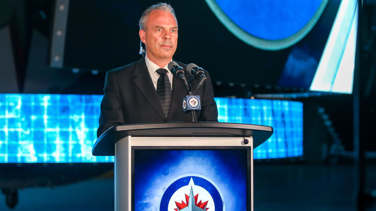WINNIPEG, MANITOBA - JULY 23: Winnipeg Jets General Manager Kevin Cheveldayoff stands at the podium as the Jets prepare to select Chaz Lucius eighteenth overall in the first round of the 2021 NHL Draft at Canada Life Centre on July 23, 2021 in Winnipeg, Manitoba, Canada. The 2021 NHL Draft was held virtually due to the ongoing Coronavirus pandemic.