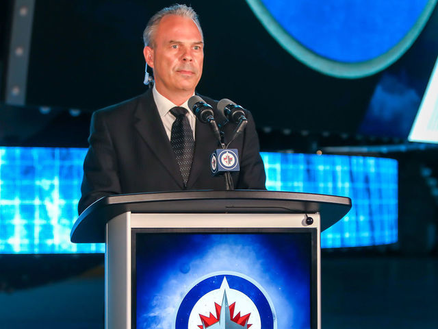 WINNIPEG, MANITOBA - JULY 23: Winnipeg Jets General Manager Kevin Cheveldayoff stands at the podium as the Jets prepare to select Chaz Lucius eighteenth overall in the first round of the 2021 NHL Draft at Canada Life Centre on July 23, 2021 in Winnipeg, Manitoba, Canada. The 2021 NHL Draft was held virtually due to the ongoing Coronavirus pandemic.