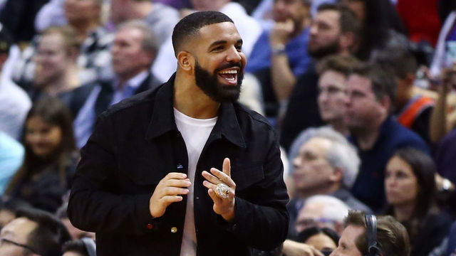 TORONTO, ON - NOVEMBER 25: Singer Drake shouts to Joel Embiid of the Philadelphia 76ers during the second half against the Toronto Raptors at Scotiabank Arena on November 25, 2019 in Toronto, Canada.