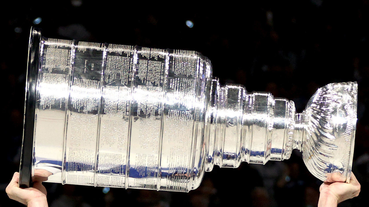 TAMPA, FLORIDA - JULY 07: Alex Killorn #17 of the Tampa Bay Lightning hoists the Stanley Cup after their 1-0 victory in Game Five of the 2021 Stanley Cup Final to win the series four games to one against the Montreal Canadiens at Amalie Arena on July 07, 2021 in Tampa, Florida.