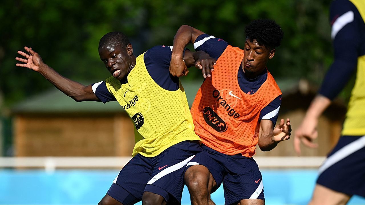 France's midfielder N'Golo Kante (L) and France's forward Kingsley Coman fight for the ball during a training session at the team's training grounds in Clairefontaine-en-Yvelines, southwest of Paris, on June 10, 2021, ahead of the UEFA EURO 2020 football competition.